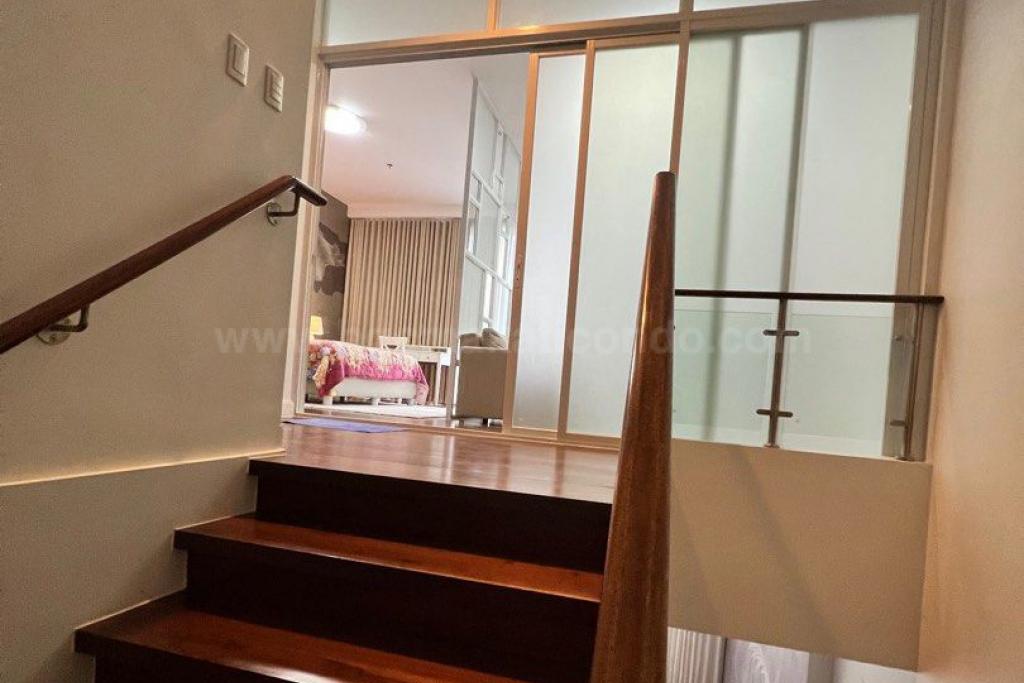 Stairs of 1-bedroom loft type condo unit at Arbor Lanes Willow