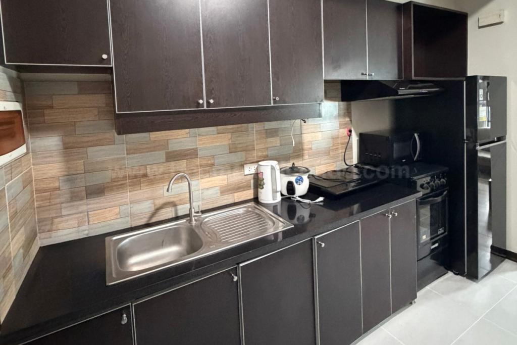 Kitchen area of 2-bedroom loft unit at The Fort Residences