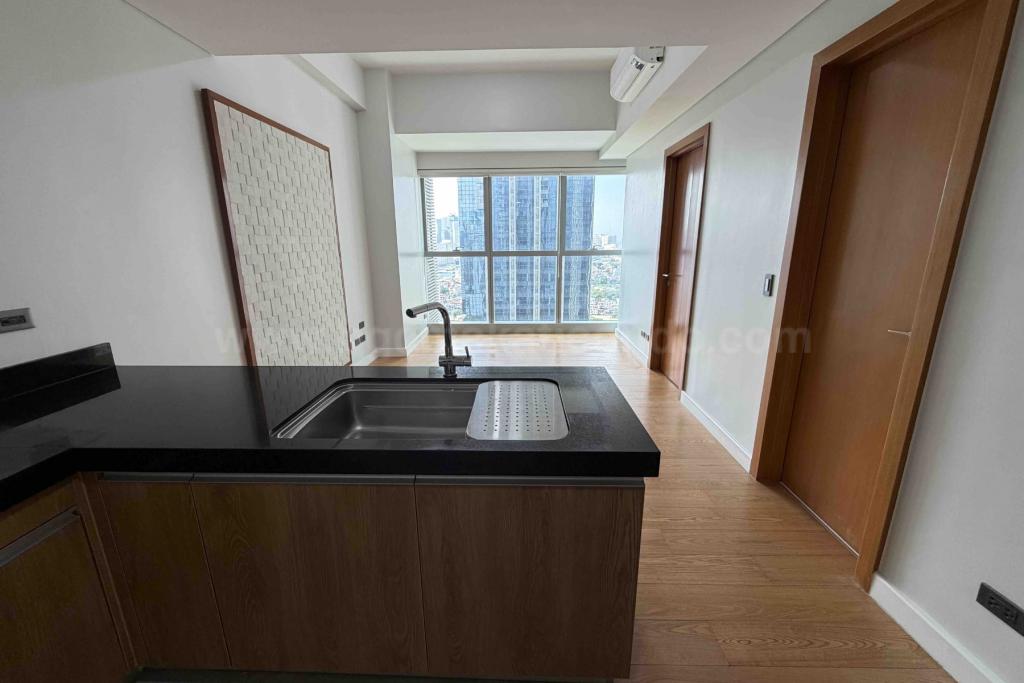 Kitchen and living areas of 1-bedroom condominium unit at The Seasons Residences