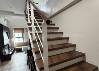 Stairs of 2-bedroom loft unit at The Fort Residences