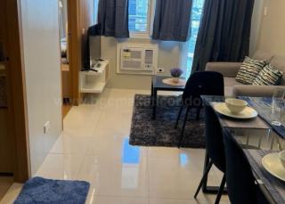 Living and dining areas of 1-bedroom condo unit at Times Square West