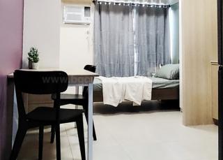 Sleeping and dining areas of studio condo unit at Avida Towers One Union Place tower 1