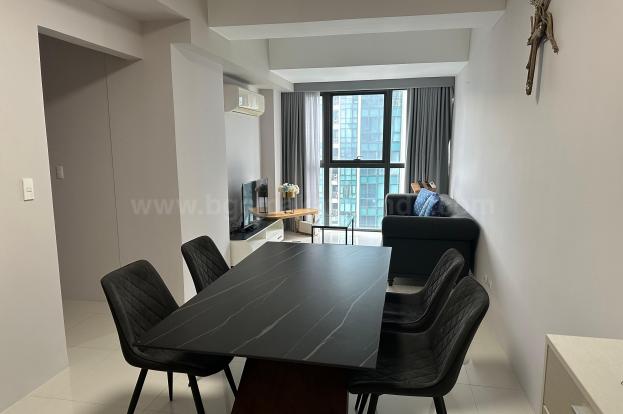 Dining and living areas of 2-bedroom condo unit at Uptown Ritz Residence
