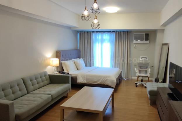 Living and sleeping areas of studio condo unit at Verve Residences
