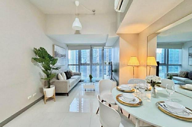 Dining and living areas of executive 2-bedroom condo unit at Uptown Parksuites tower 1