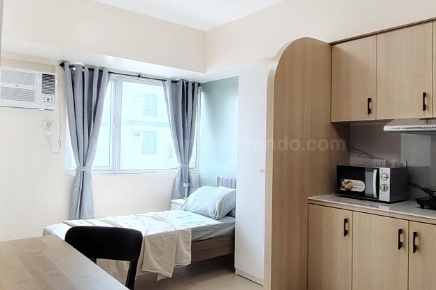 Sleeping and kitchen areas of studio condo unit at Avida Towers One Union Place tower 1